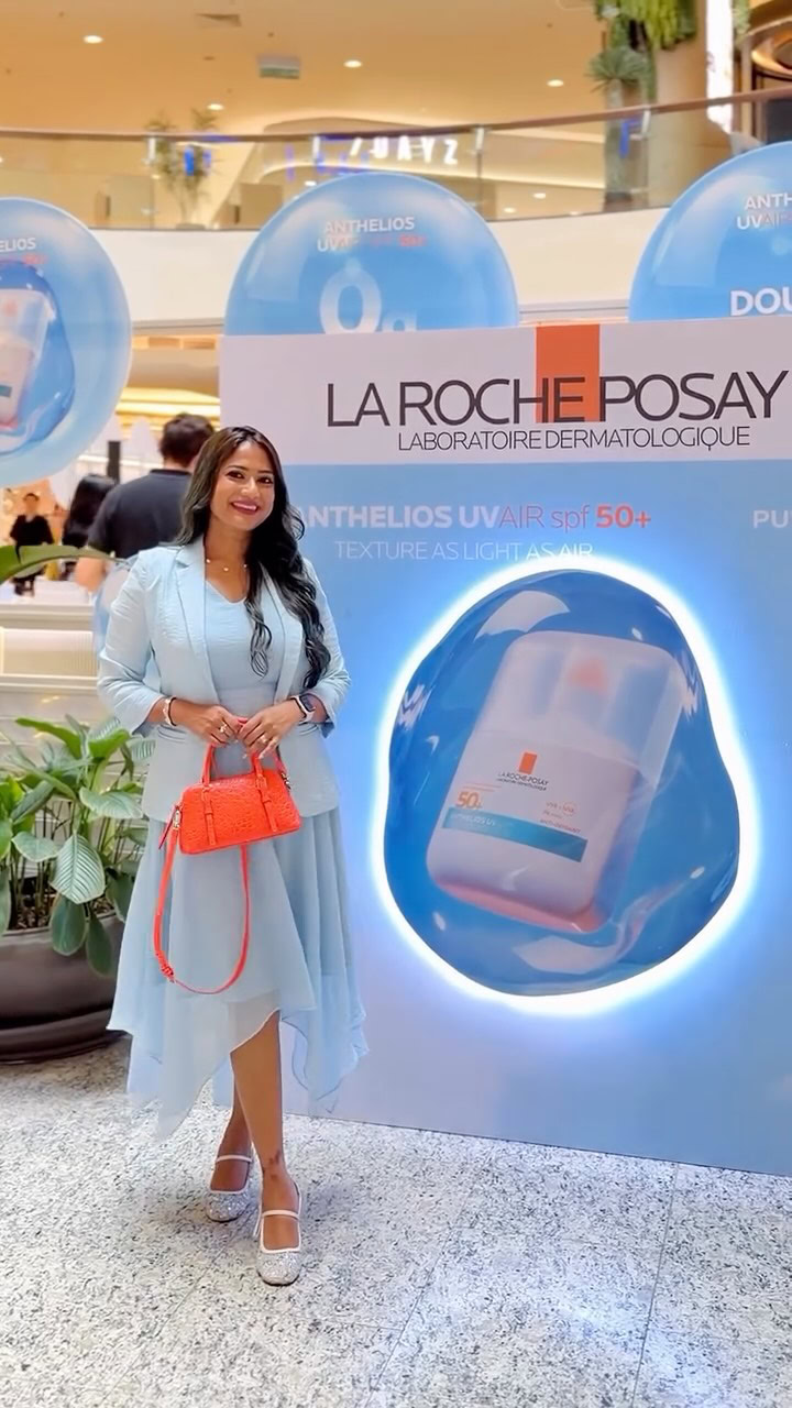 Beautiful woman at La Roche-Posay skincare booth in shopping mall.